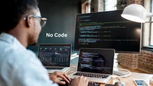 A person coding on multiple screens